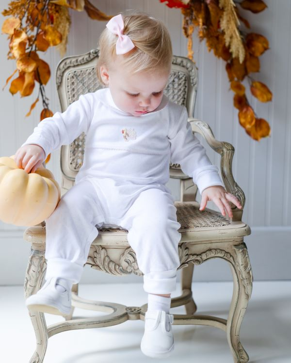toddler girl wearing pink dot playsuit with hand embroidered turkey