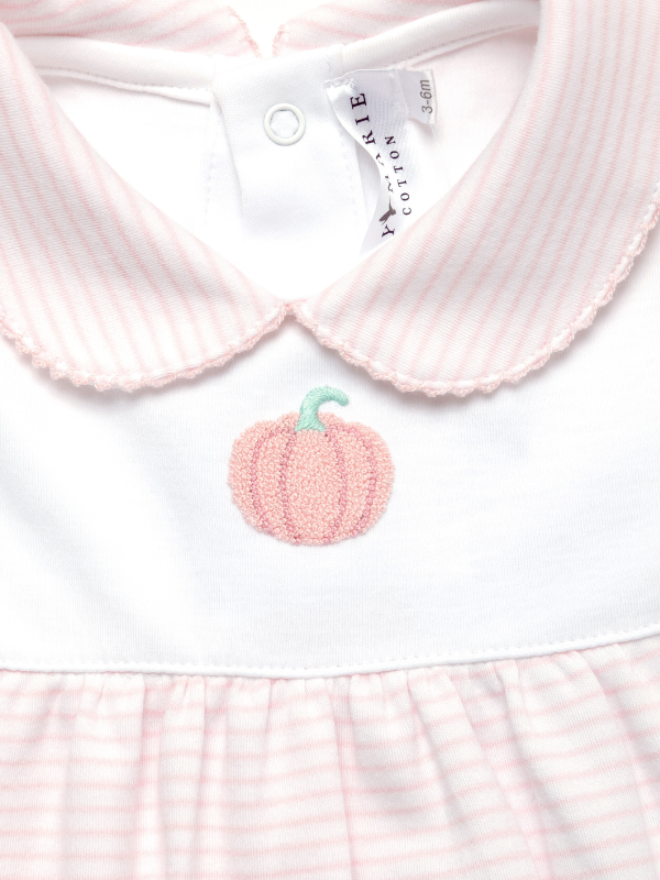 Children's outfit with pink collar and embroidered pumpkin on a white background