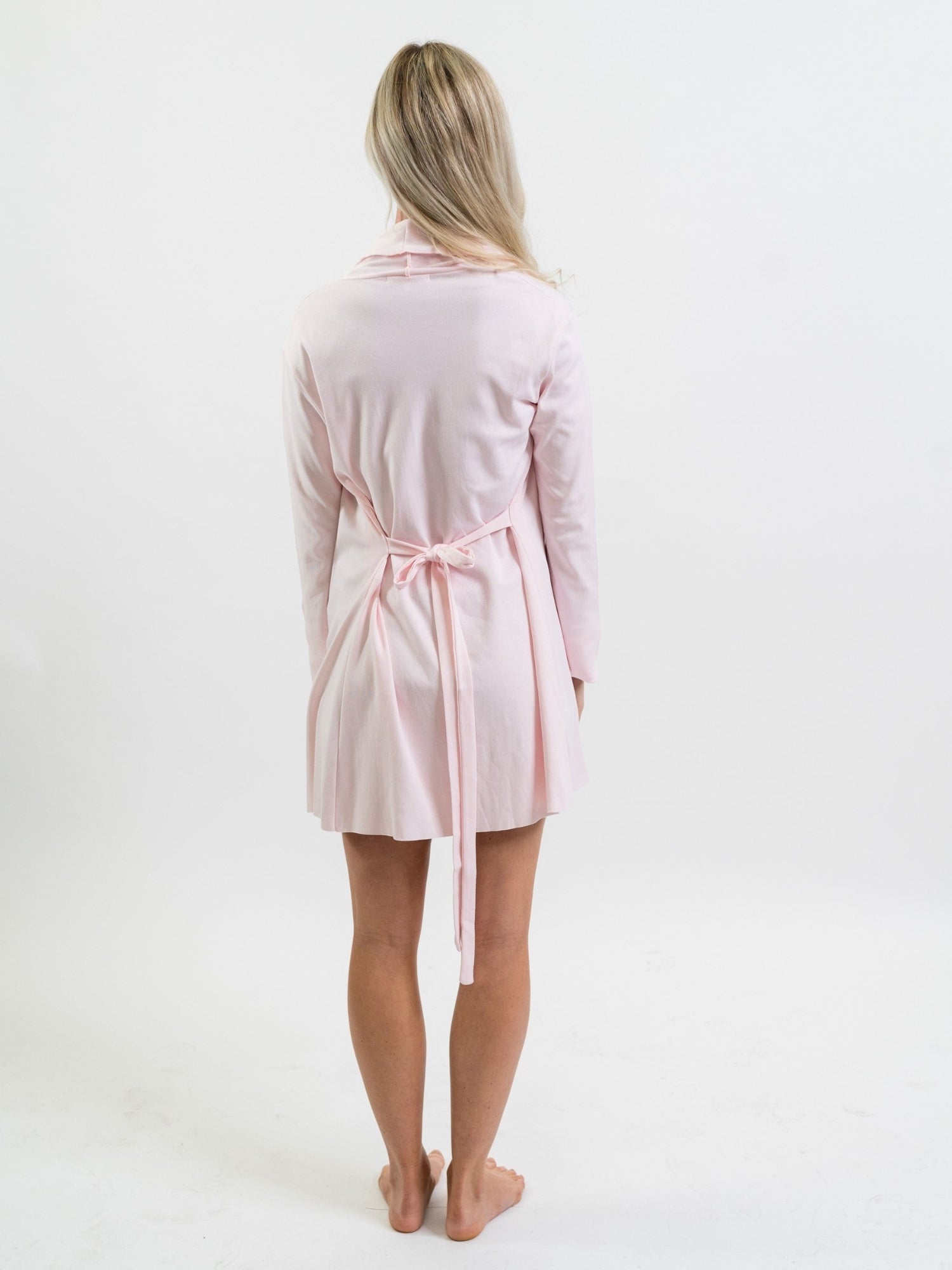 Woman wearing a light pink Pima cotton robe on a white background - showing back of garment