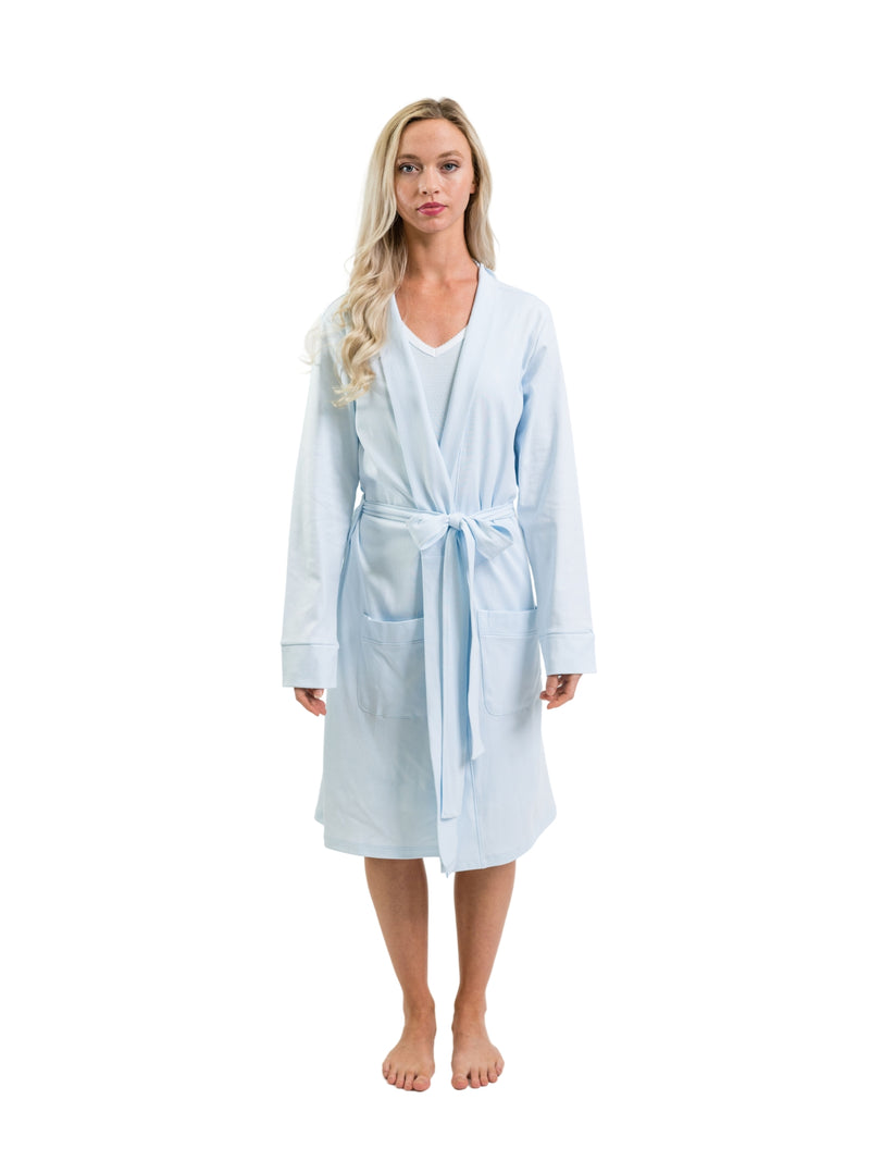 Woman wearing a light blue robe on a white background